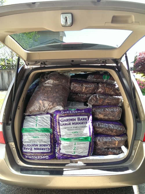 The minivan all loaded up with bark for the dog kennel