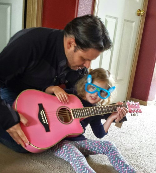 Ava checking out her new guitar