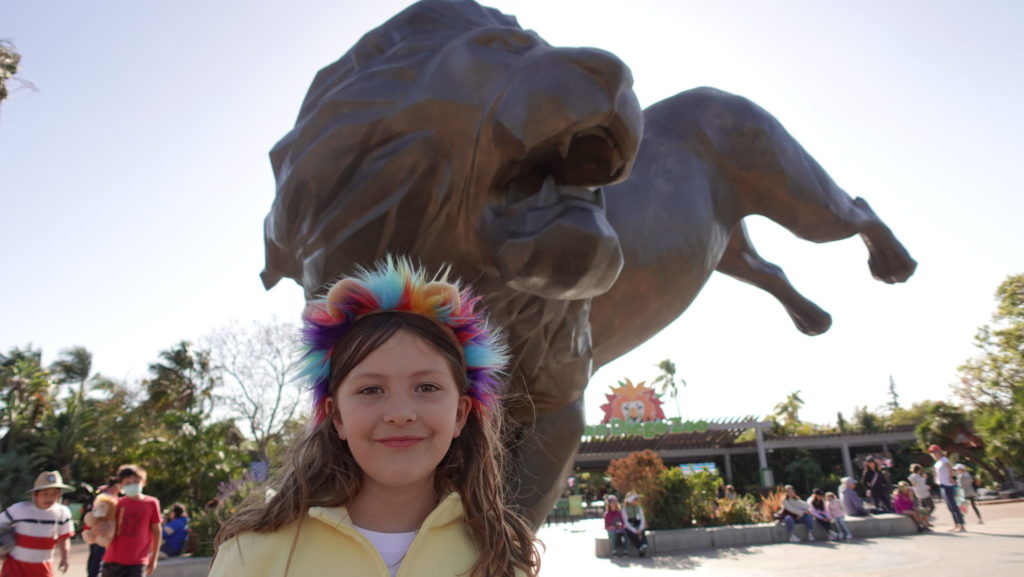 Elise Pellegrini with the lion statue at the San Diego Zoo