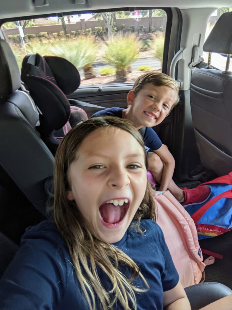 Elise and Enzo Pellegrini being silly in the car.