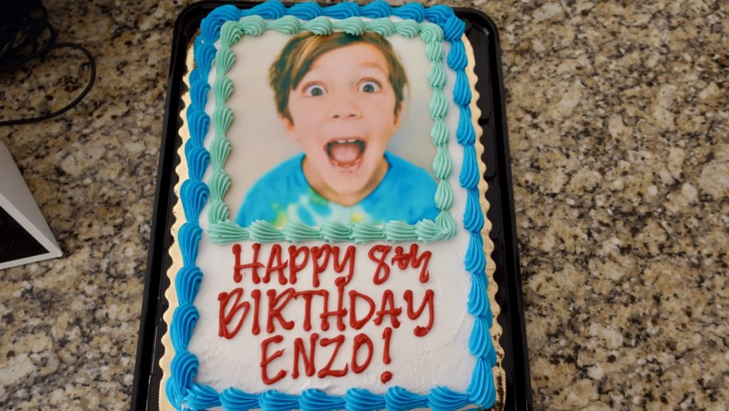 Enzo's 8th birthday cake with his face printed on top.