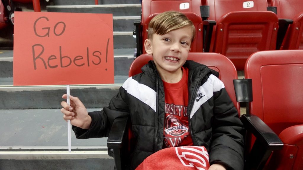 Enzo with his "Go Rebels" sign before the start of the game.