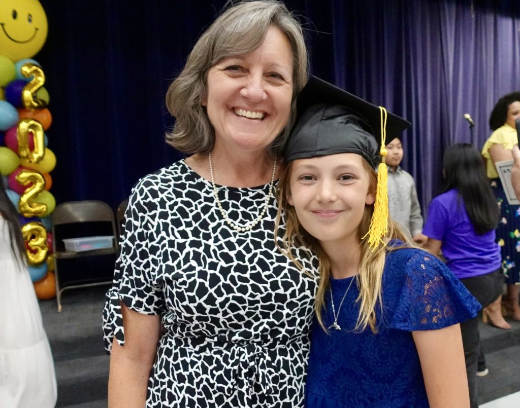 Ava and her teacher at 5th grade graduation