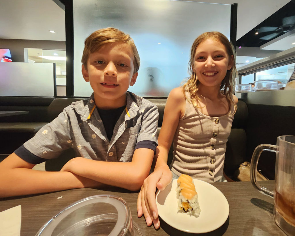 Enzo and Ava having conveyor sushi for the first time