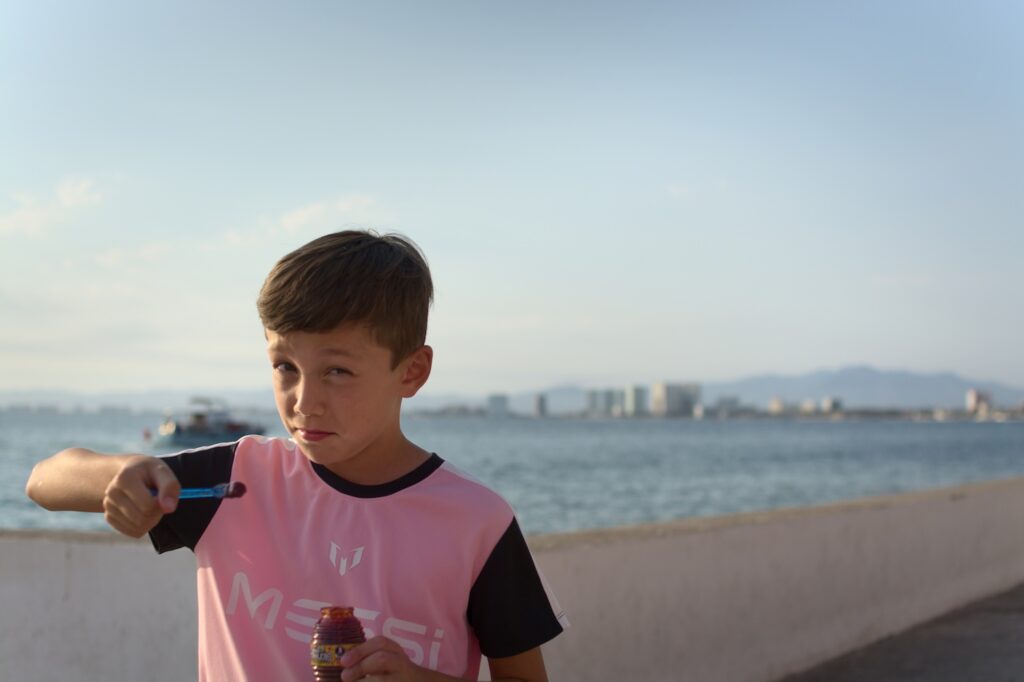 Enzo Pellegrini eating candy on the Puerto Vallarta Malecon