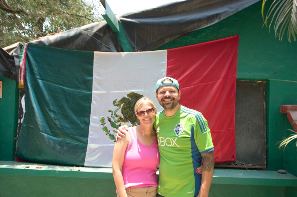 Jessica & Michael Pellegrini in front of the Mexican flag