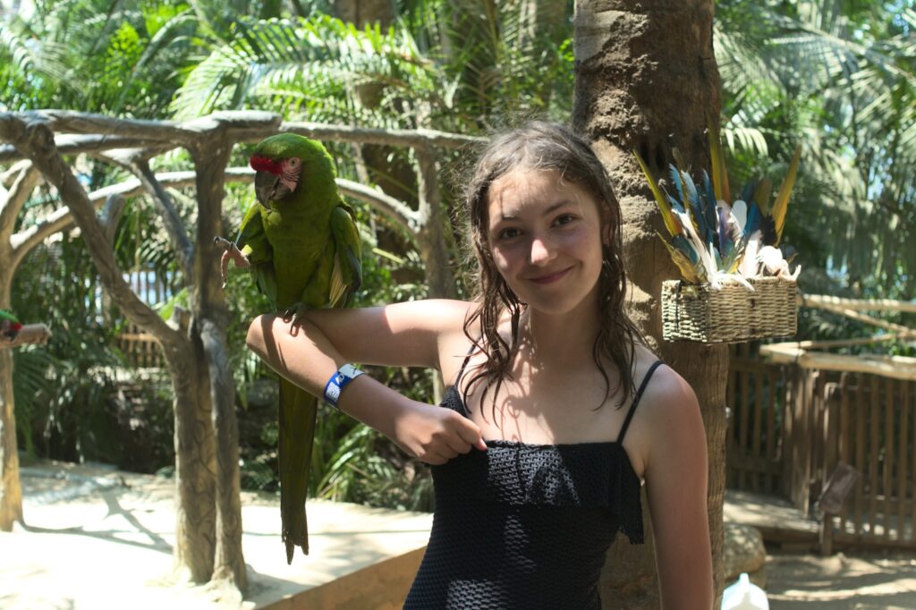 Ava Pellegrini holding a Macaw in Mexico