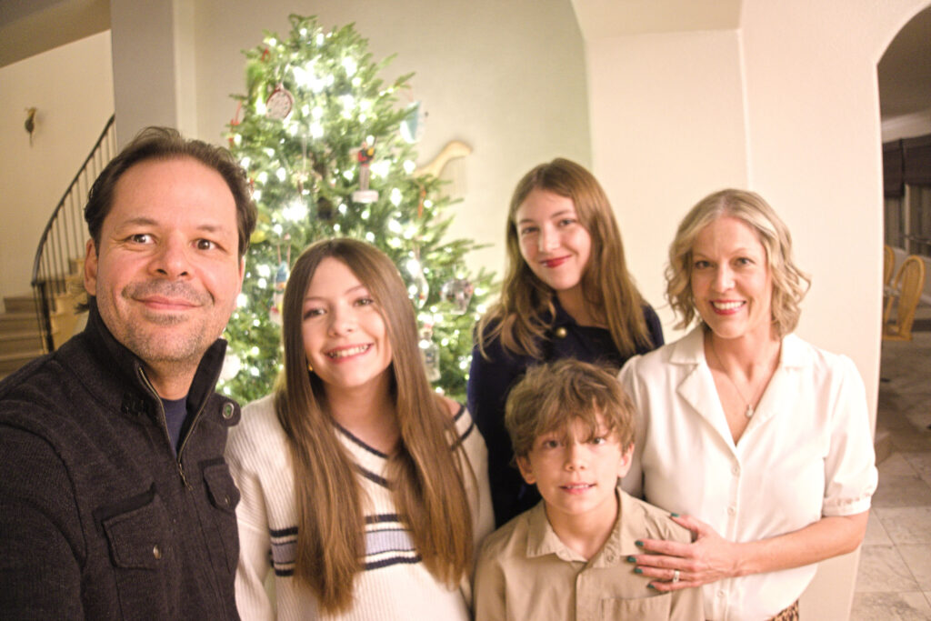 The Pellegrini family in front of their Christmas tree, Dec 2025