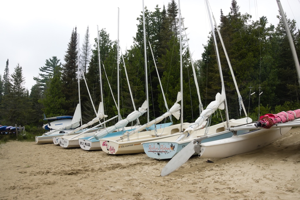 A row of sailboats on the beach on Lake Huron